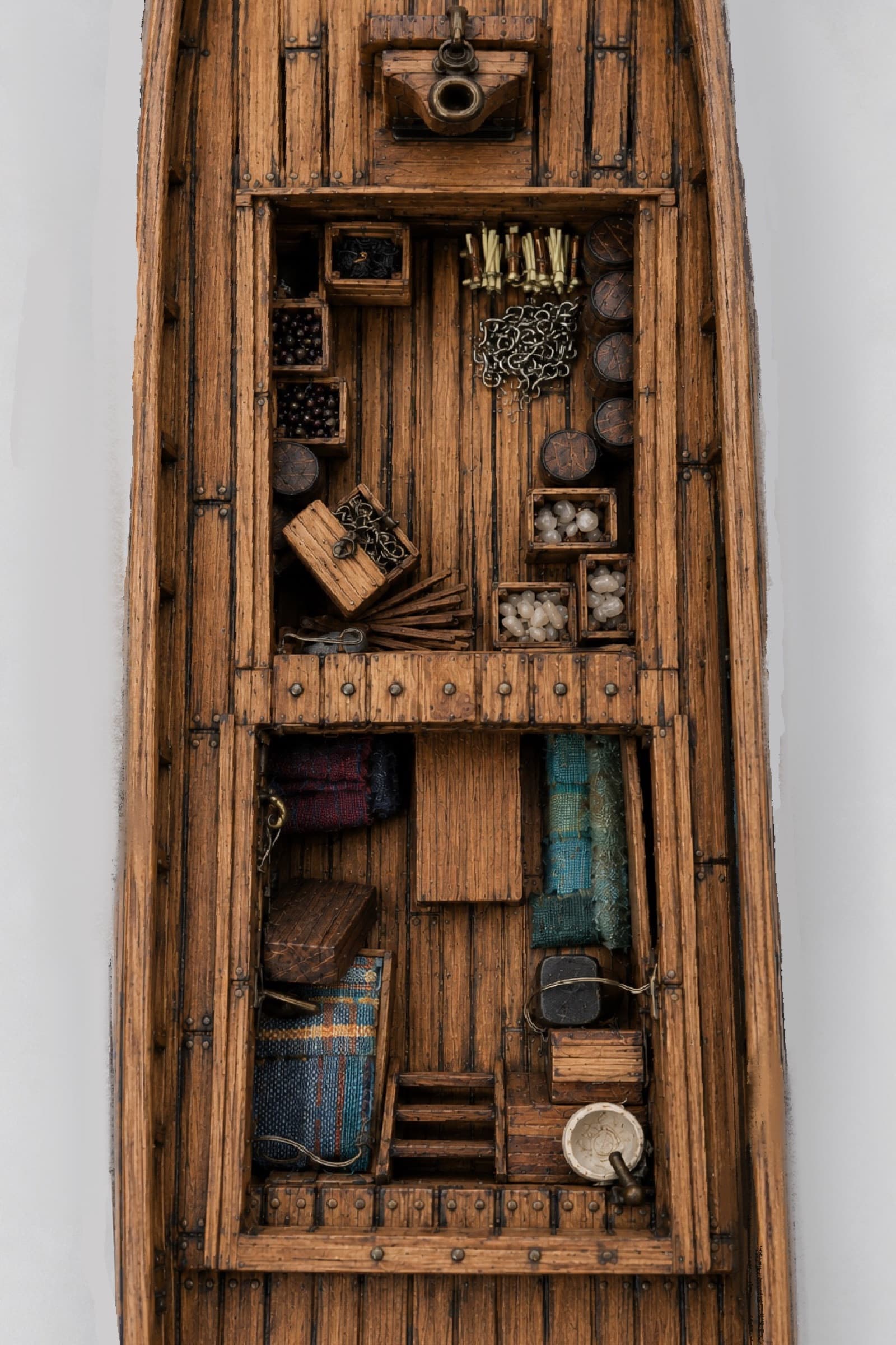 Inside the hull: rope, chain, canvas, and tiny fittings packed into the hold